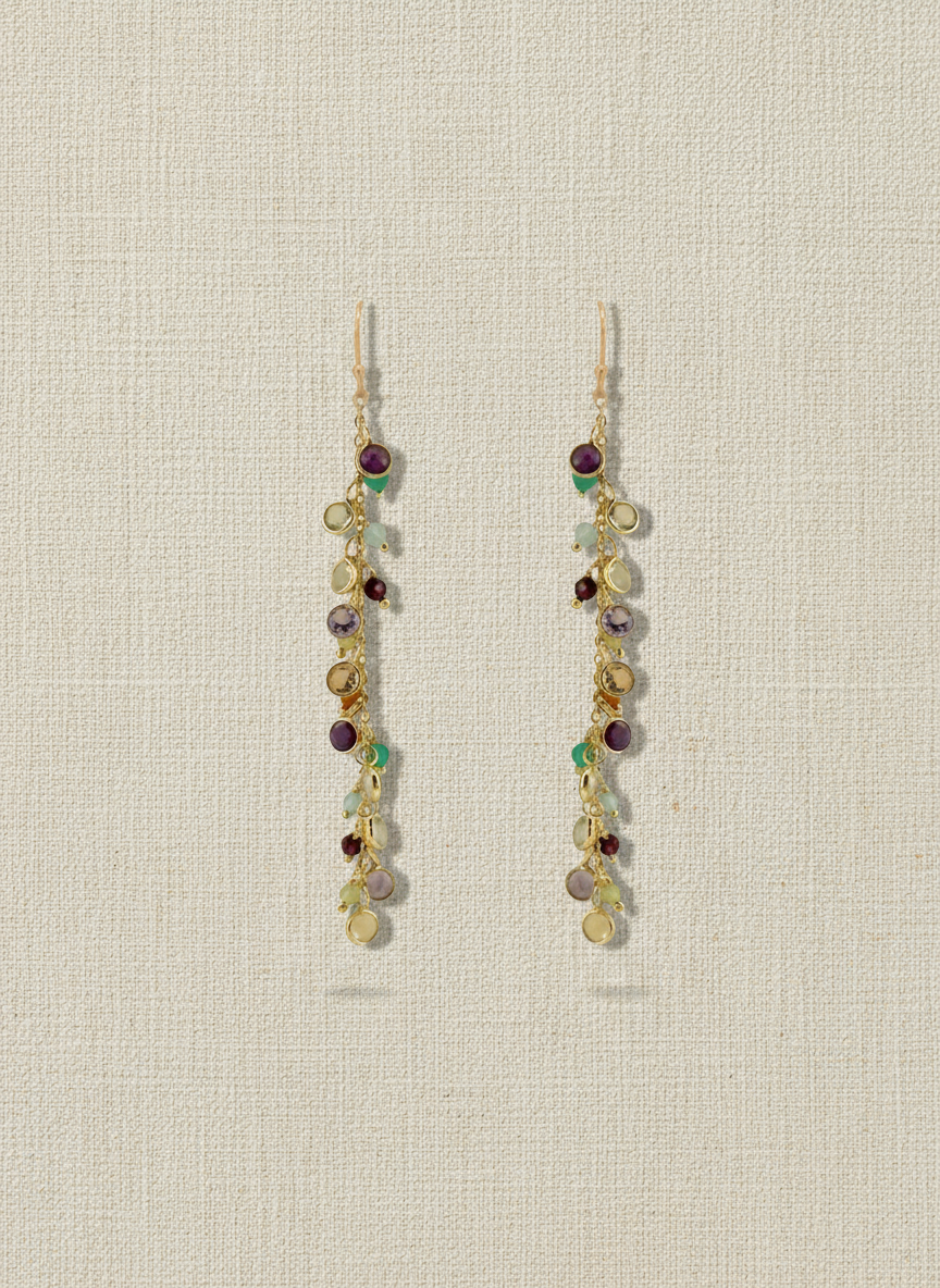 Gold earrings with multicolored beads on a white background