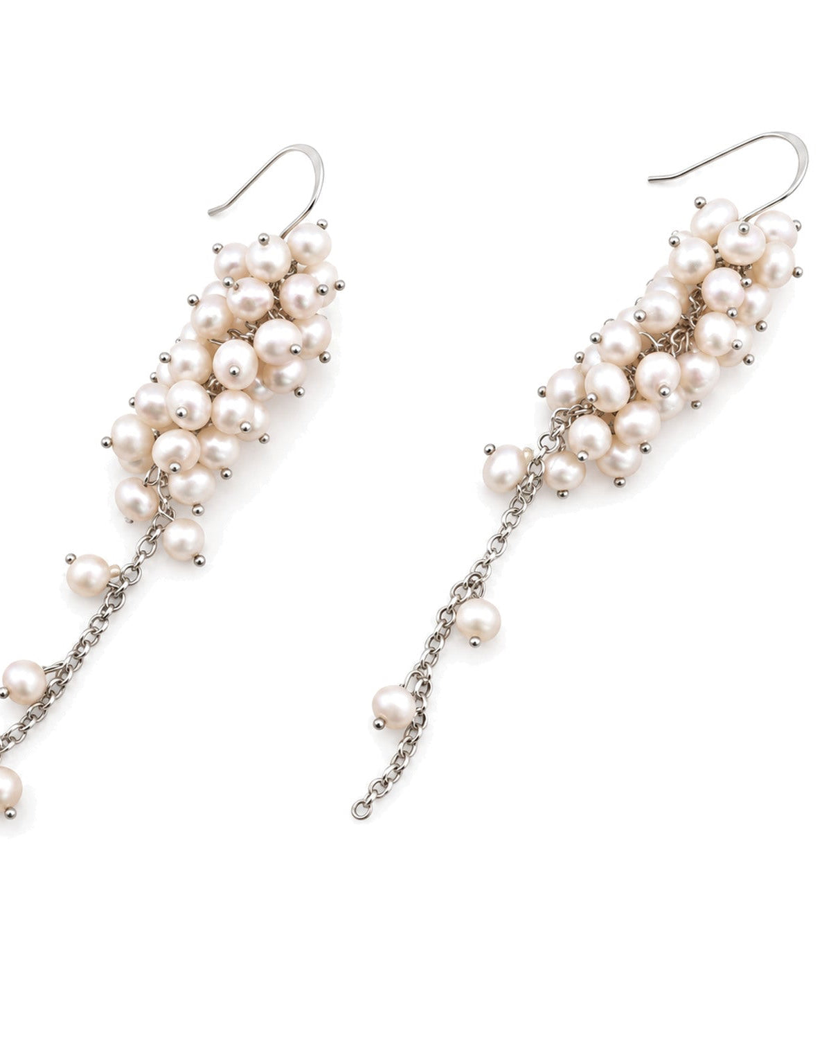 A pair of silver-tone drop earrings featuring clusters of small, lustrous white pearls on curved hooks with dangling chain accents, shown against a plain white background.