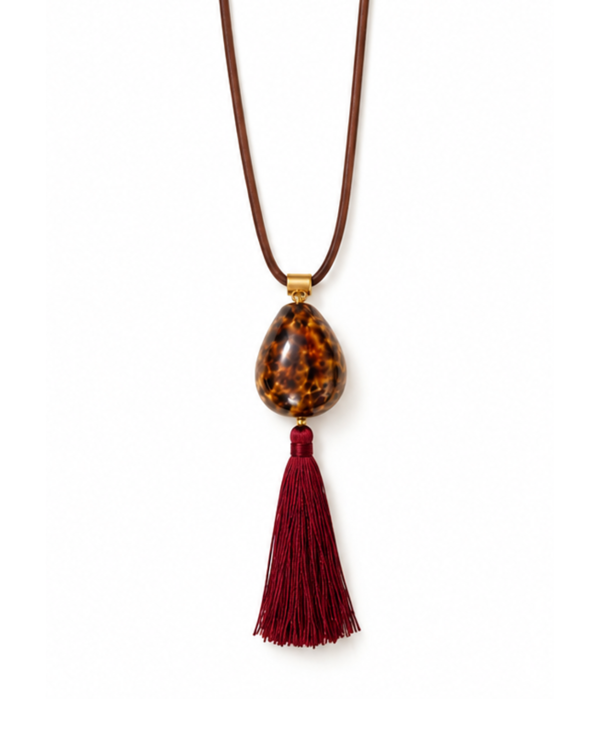 A long brown cord necklace featuring a teardrop-shaped brown and amber tortoiseshell bead pendant with a long dark red tassel hanging below, set against a plain white background.