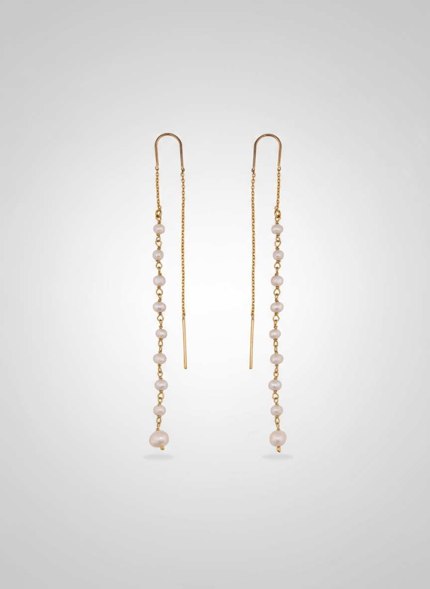 A pair of thread-thru earrings featuring freshwater pearls on an 18k gold plated sterling silver chain.