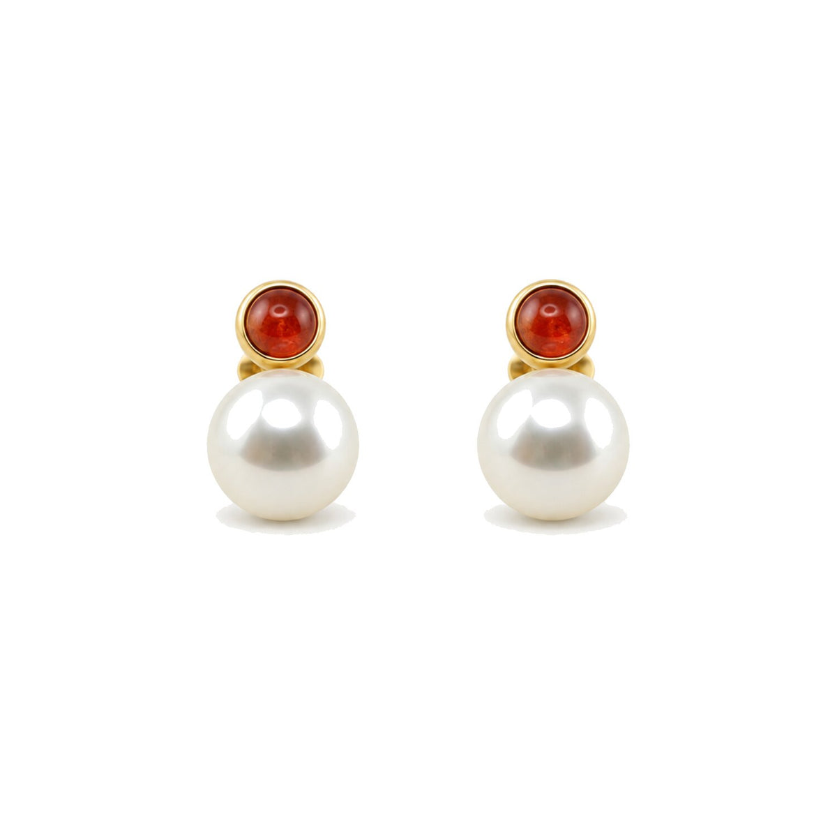 A pair of gold stud earrings featuring a large white pearl and a small round red cabochon stone set in gold.