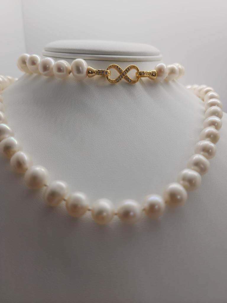 Presenting the Forever Pearl Necklace, a luxurious and timeless piece of art. Hand knotted with freshwater pearls, this ultra long necklace can be worn in so many unique ways- as a belt, or a necklace- lending a touch of sophistication and glamour for every occasion. Its beautiful 14k gold plated silver closure completes the look of modern elegance.  Each pearl carries a unique luminosity, and their timeless beauty elevates any outfit, from casual ensembles to formal occasions.