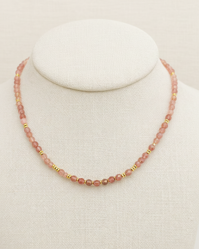 Necklace with pink beads on a white background