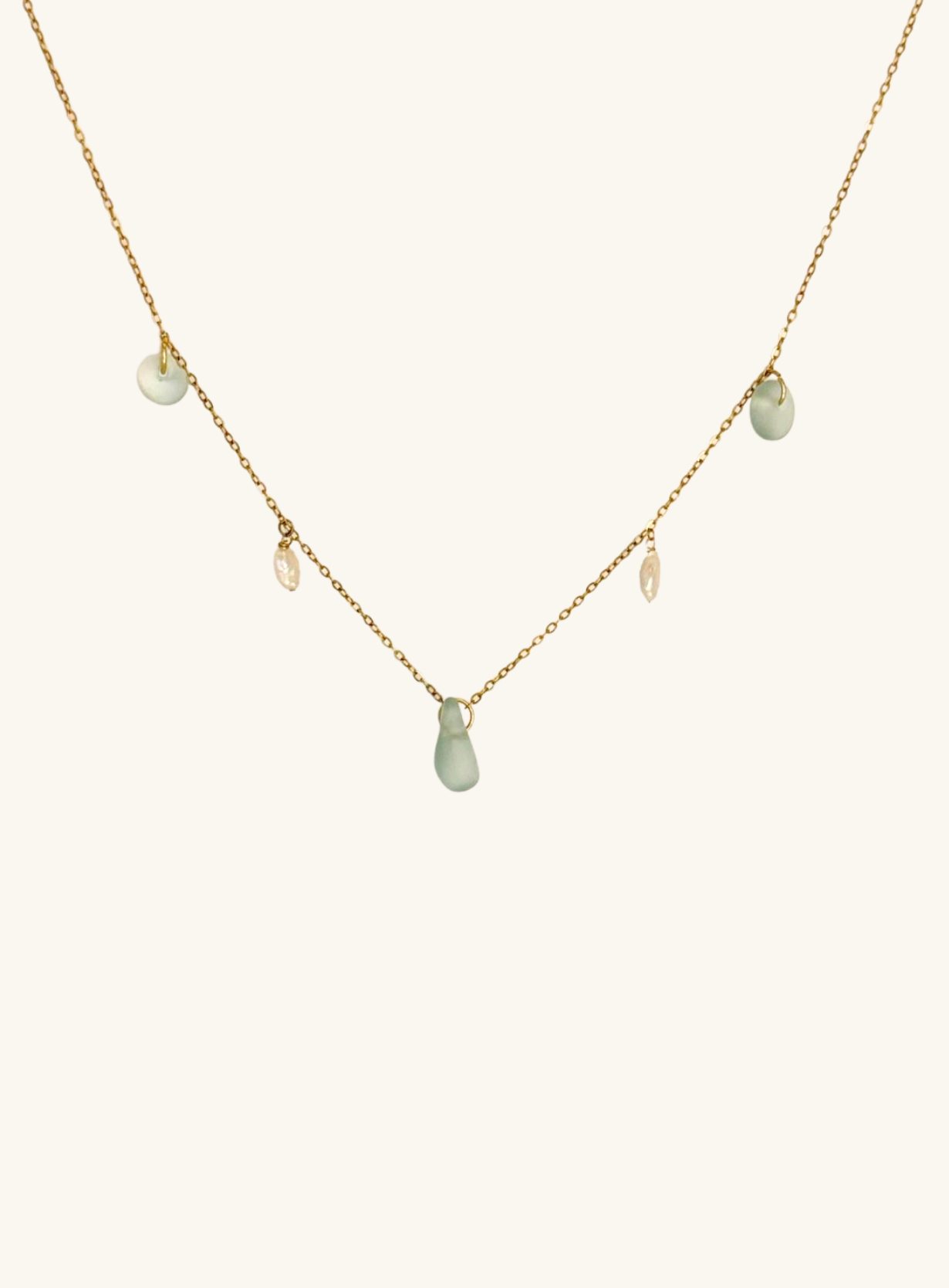 Necklace with green teardrop-shaped pendants on a white background