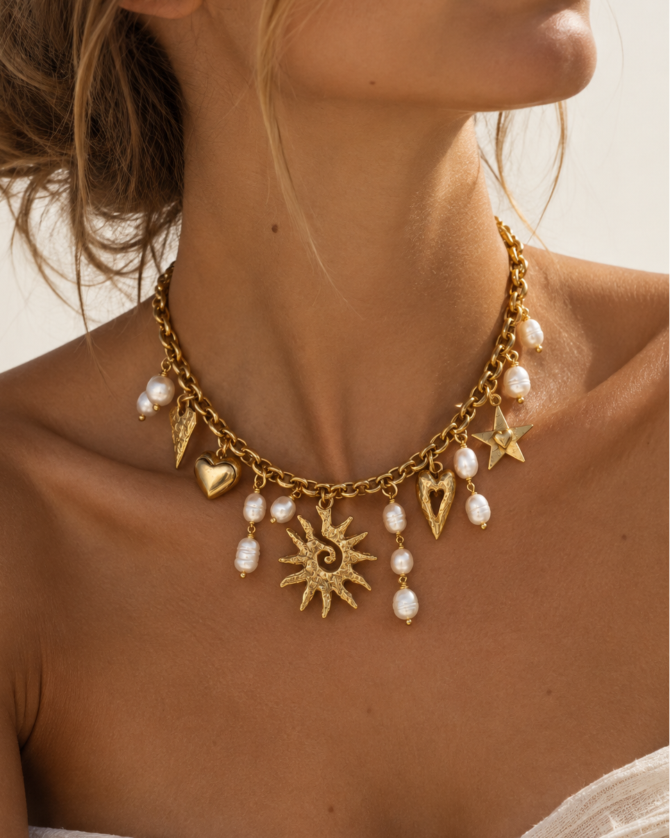 Discover the Solimar Pearl Charm Necklace with freshwater pearls, antiqued 18k gold-plated vintage brass, and a toggle clasp. Handmade in Florida.